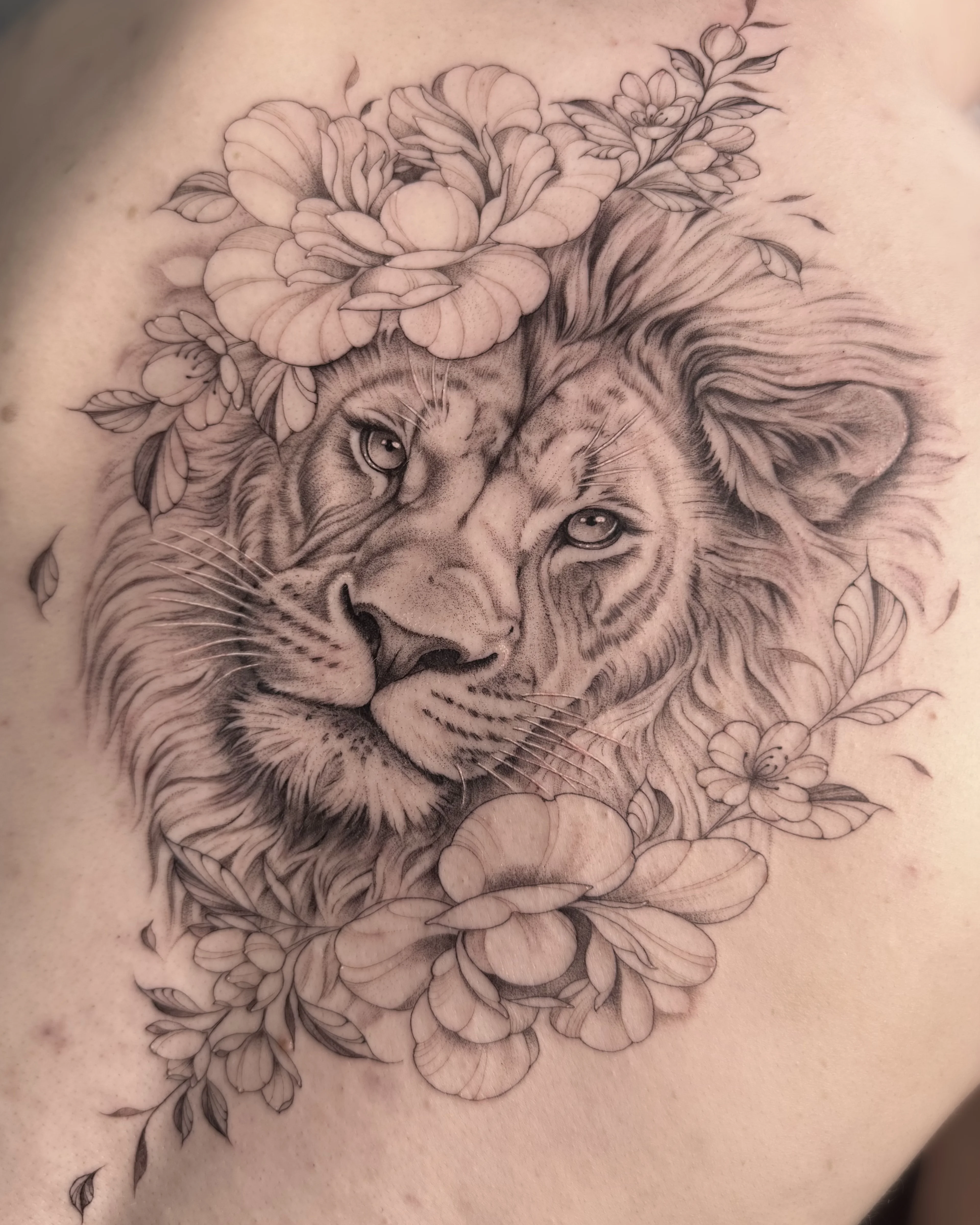 Black & Gray Realism tattoo by Abigail Louise: lion, flowers, leaves, animal