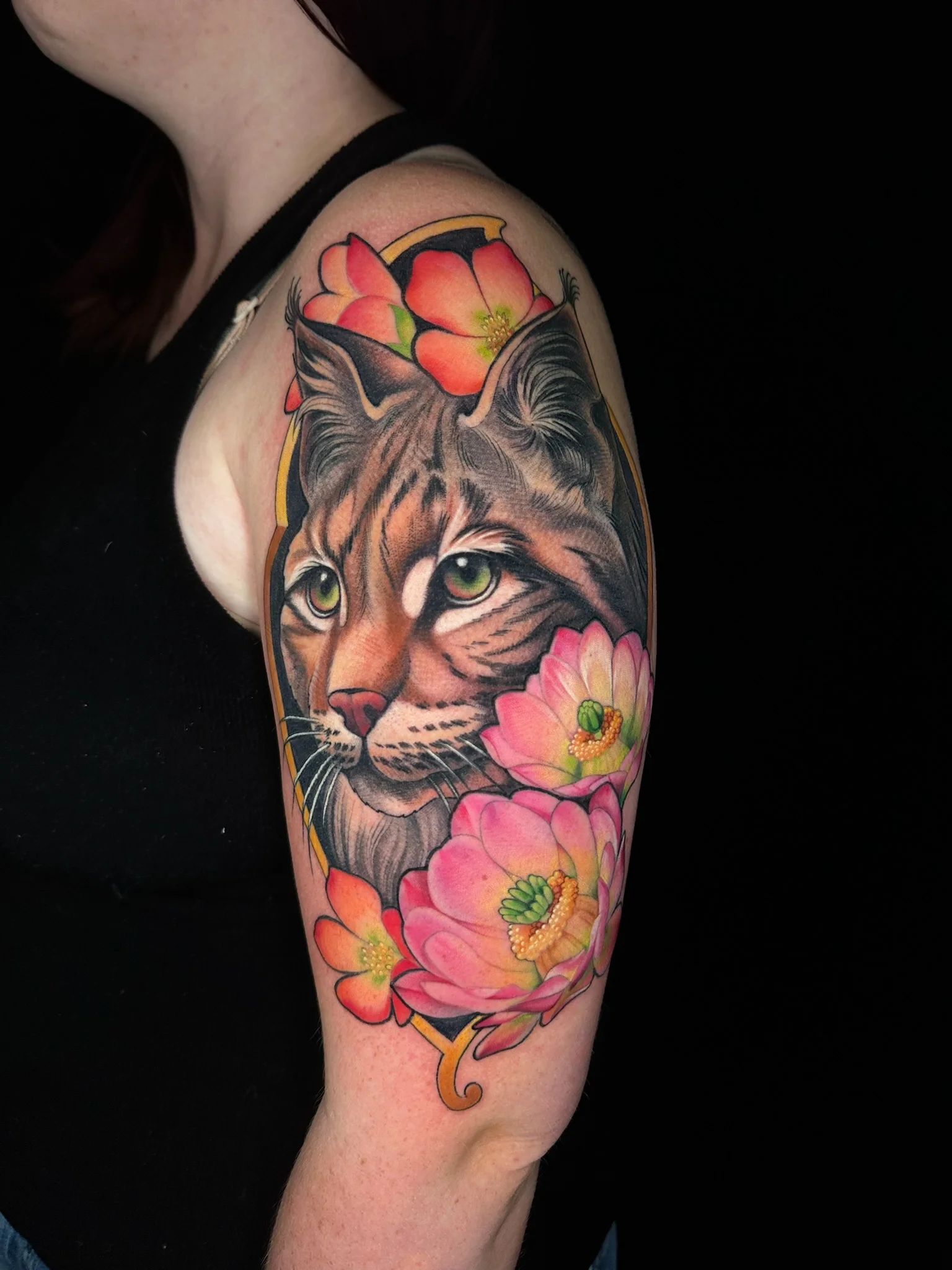 Color Realism tattoo by Stephanie Heffron: bobcat, flower, lotus flower, animal