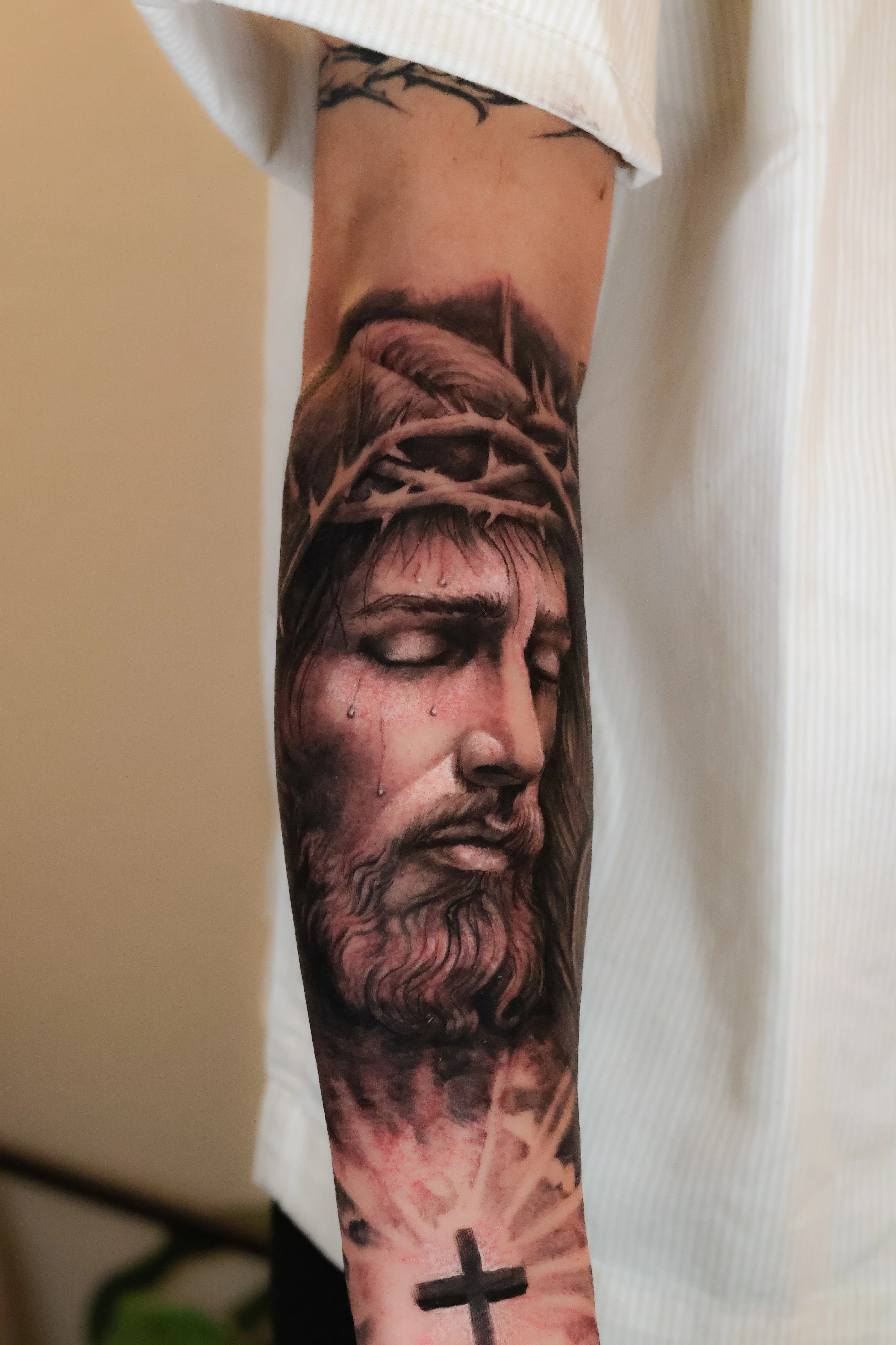 Black & Gray Realism tattoo by Emiliano Garrido: jesus, crown of thorns, cross, tears