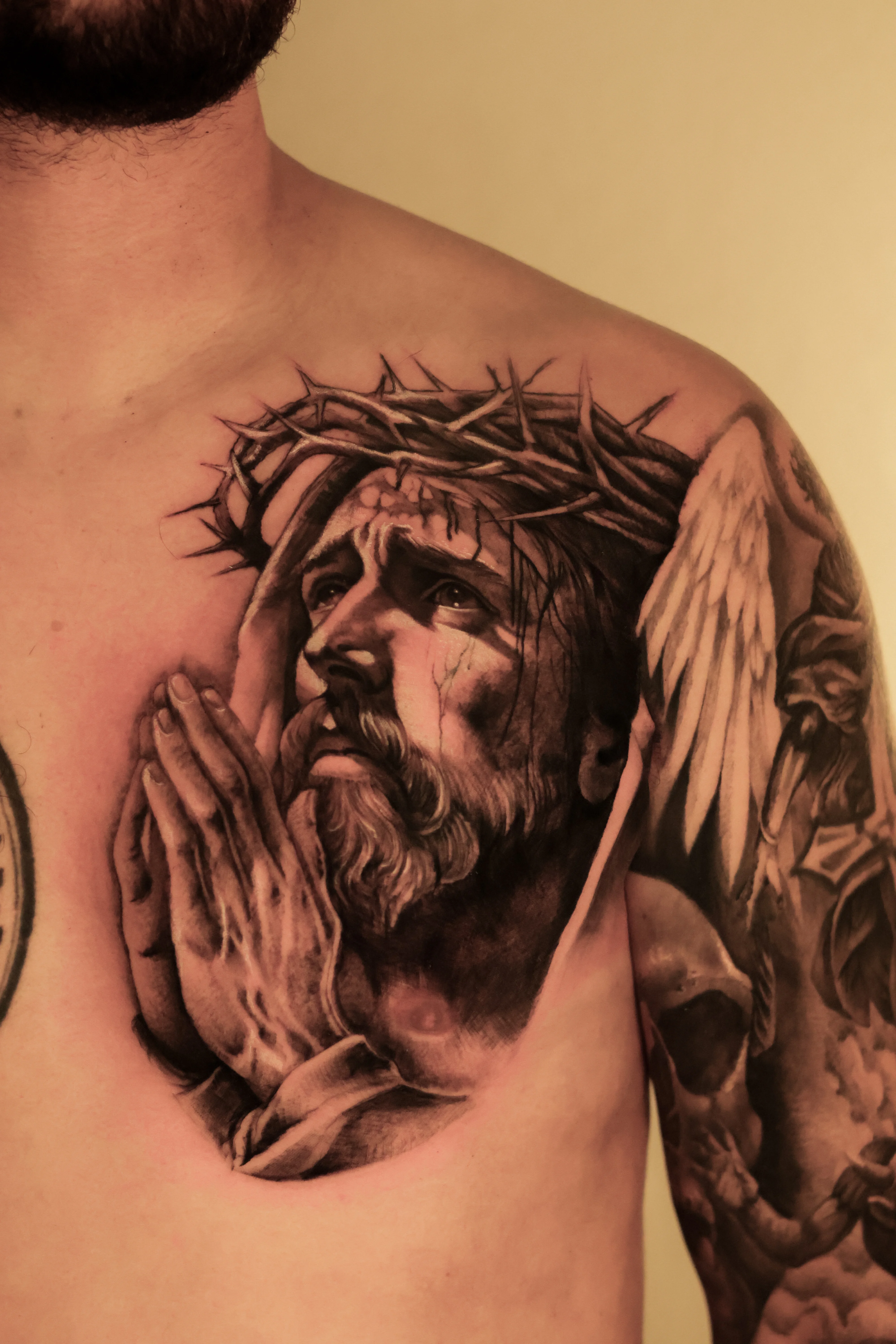 Black & Gray Realism tattoo by Emiliano Garrido: jesus, crown of thorns, praying hands, angel wing