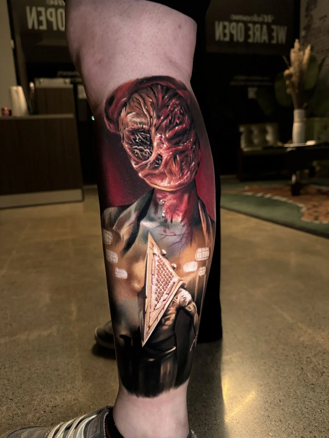 Color Realism tattoo by Alex Moro: pyramid head, distorted face, blood, chains