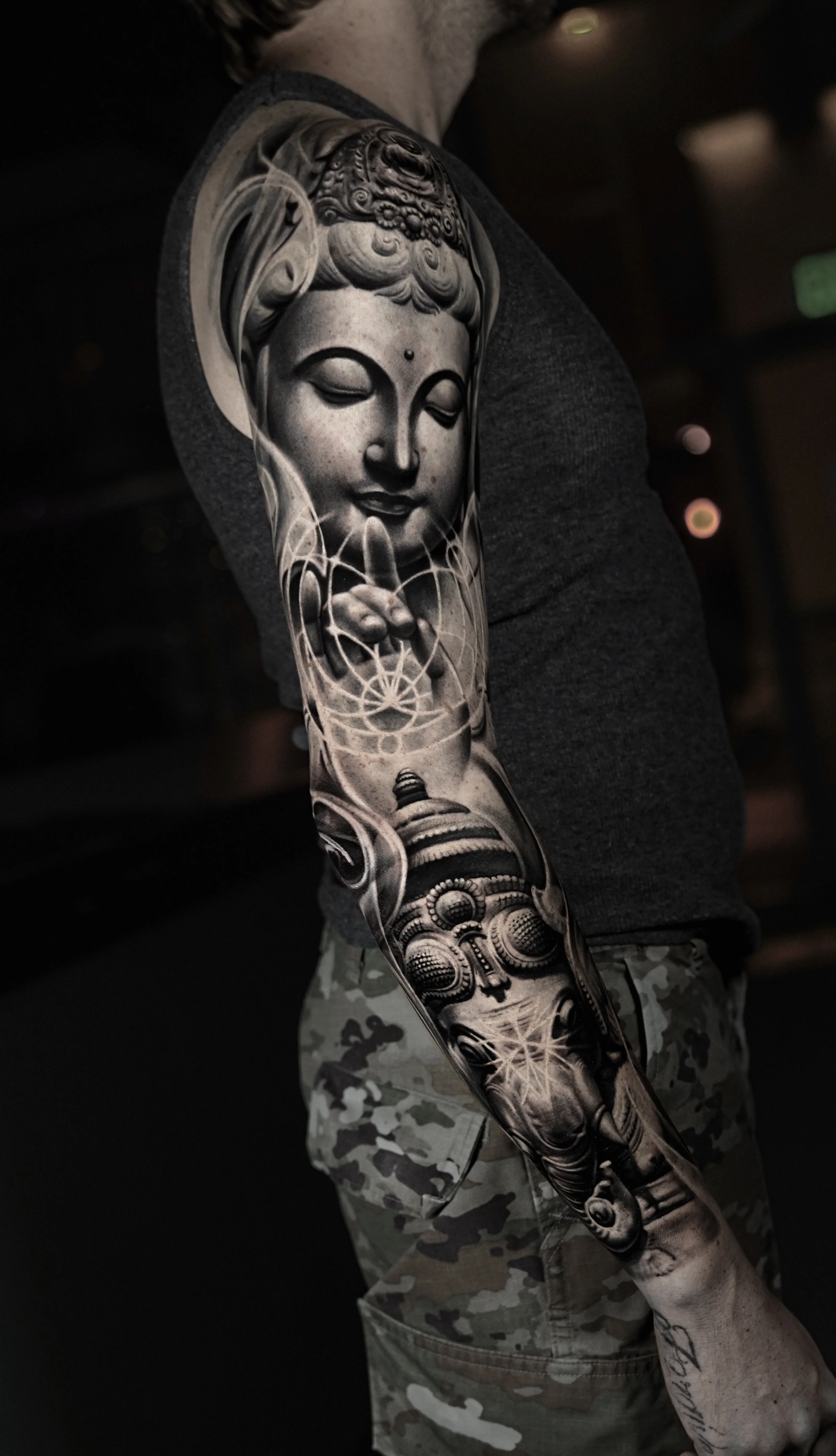Black & Gray Realism tattoo by Camilo Gonzalez: buddha, hand gesture, mandala pattern, praying figure
