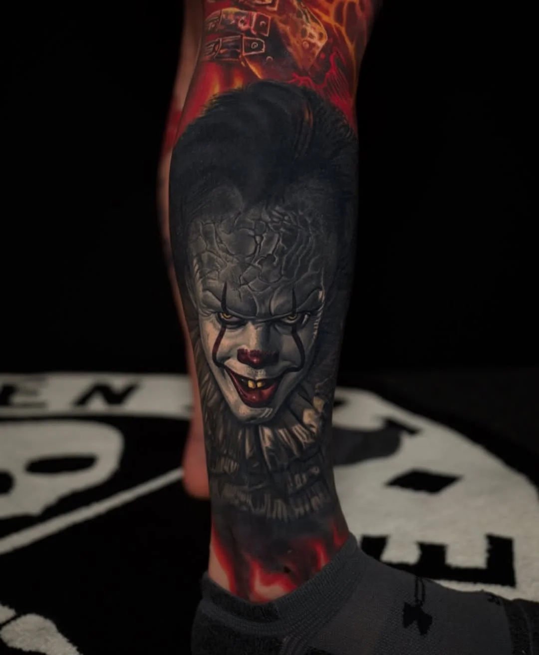 Black & Gray Realism tattoo by Nikko Hurtado: clown face, sharp teeth, dark hair, face paint
