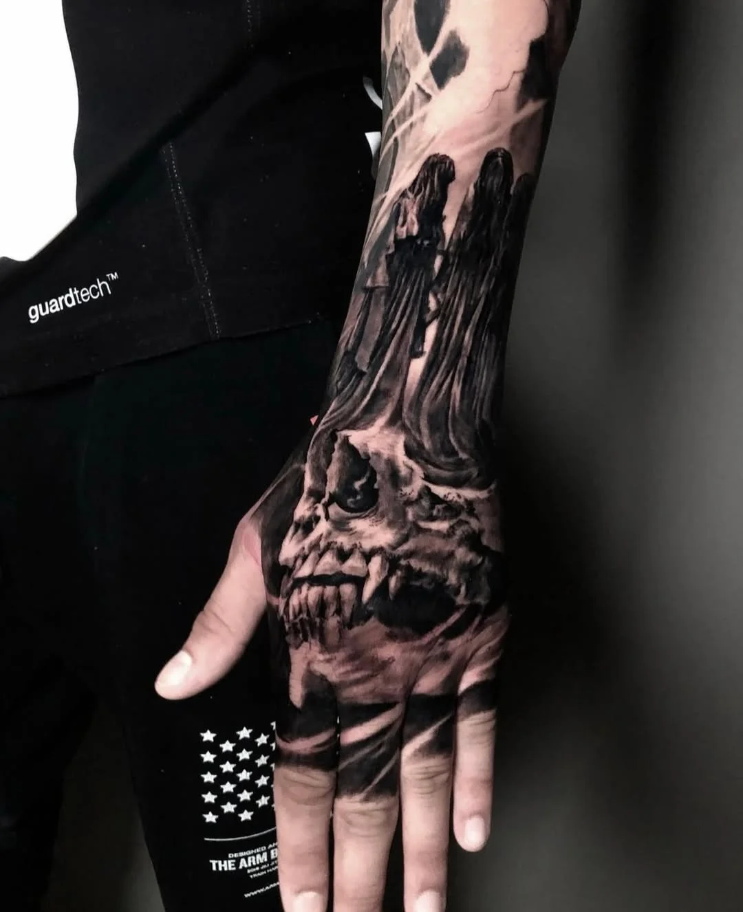 Gothic Skull and Women Hand Tattoo: skull, teeth, cloaked figures, smoke, dark, gothic