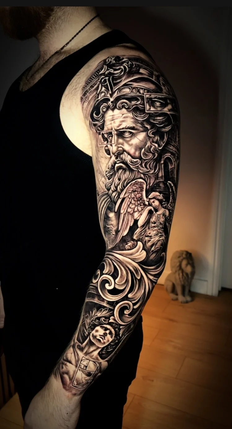 Black & Gray Realism tattoo by TOAD: ancient bearded man, helmet, angel, scrollwork