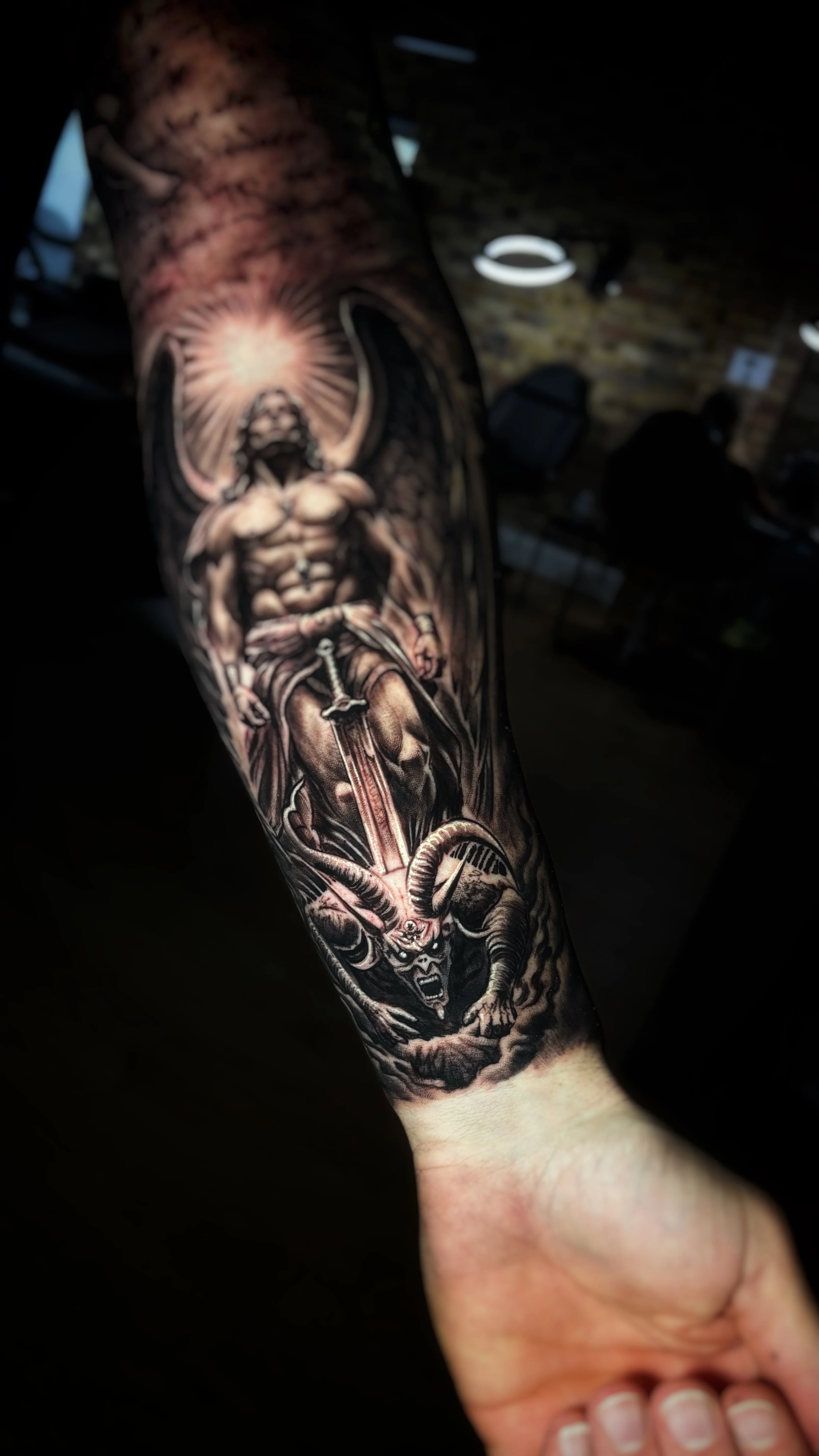 Black & Gray Realism tattoo by TOAD: angel, sword, demon, horns