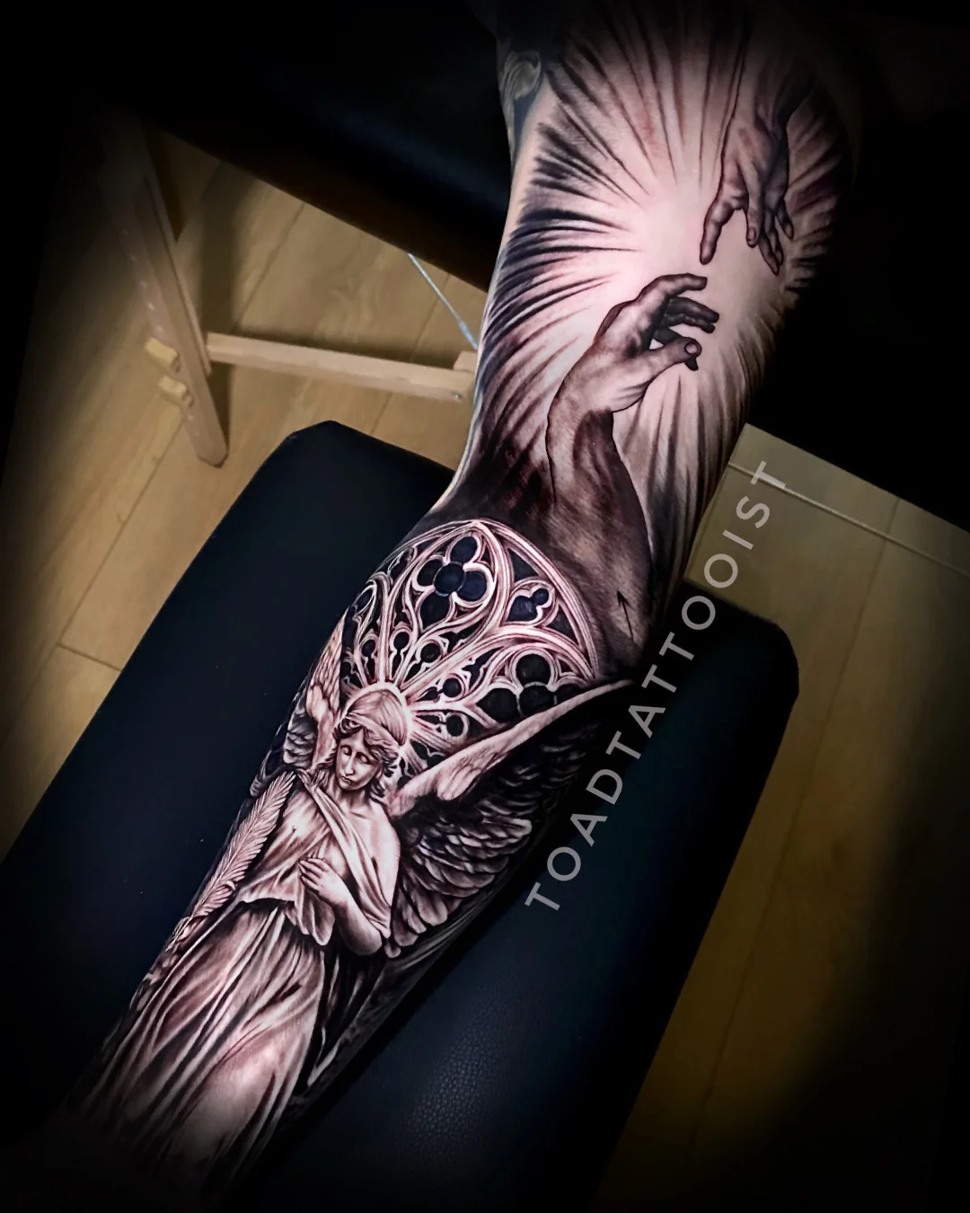 Black & Gray Realism tattoo by TOAD: angel, outstretched hand, reaching hand, wing