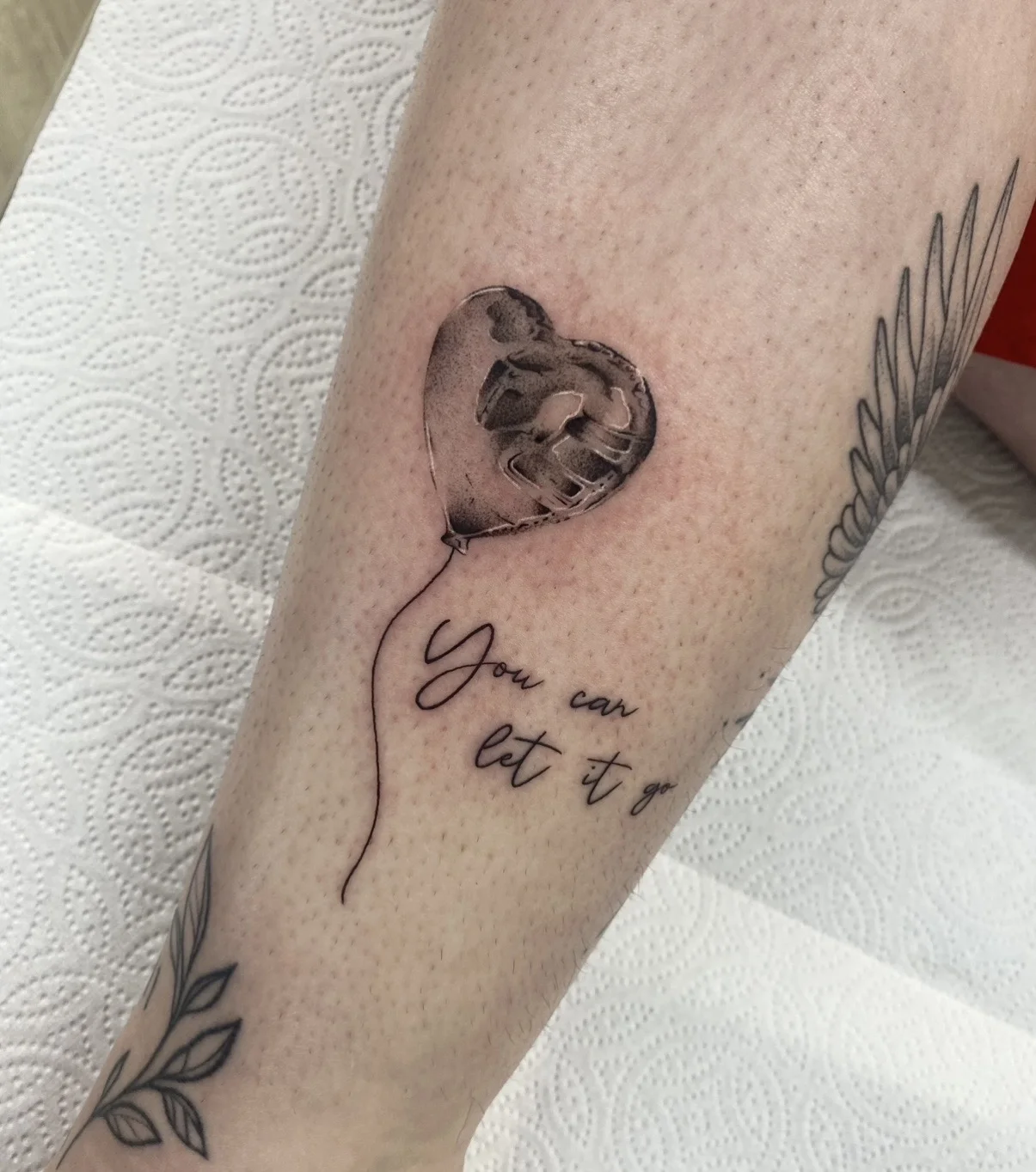 Fine Line tattoo by Aliye Gaygusuz: heart-shaped balloon, hand fist, romantic, inspirational