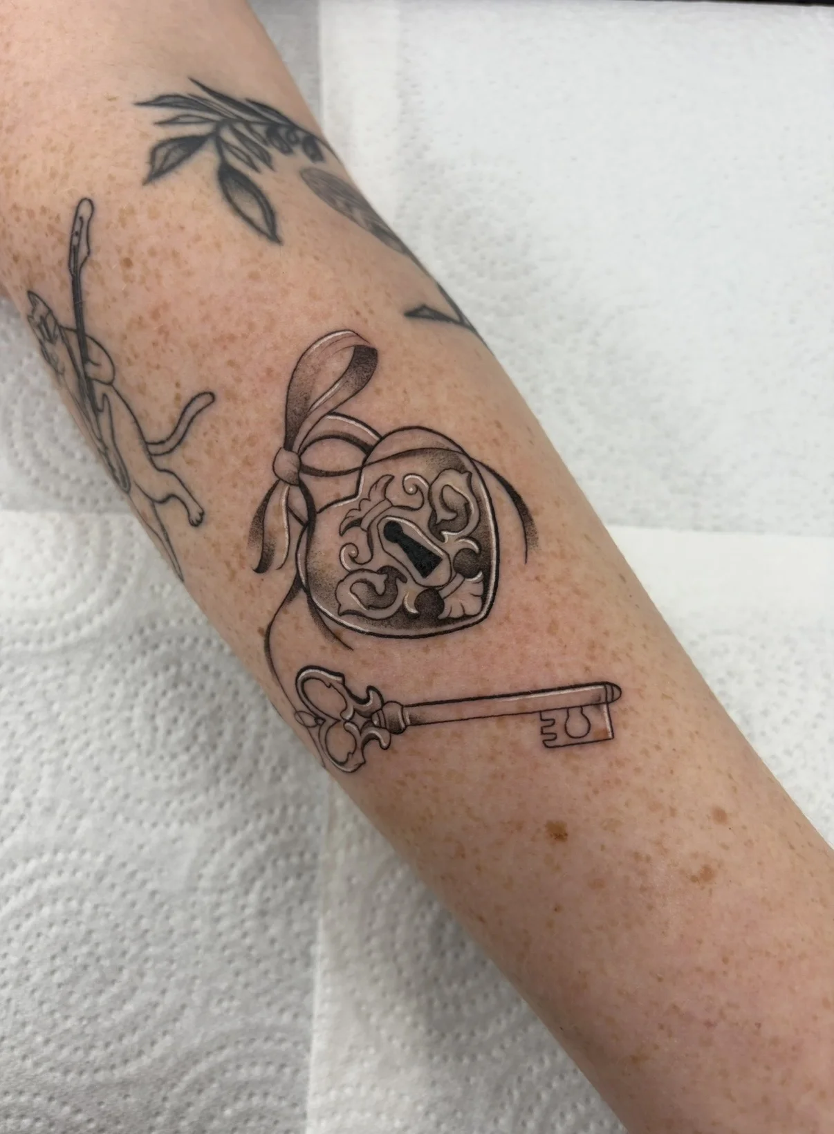Fine Line tattoo by Aliye Gaygusuz: heart lock, key, bow, romantic