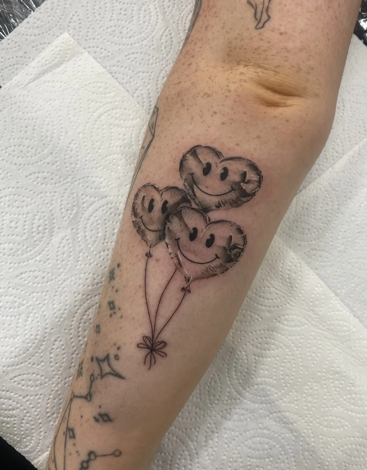 Fine Line tattoo by Aliye Gaygusuz: heart-shaped balloon, balloon, smiley face, bow knot
