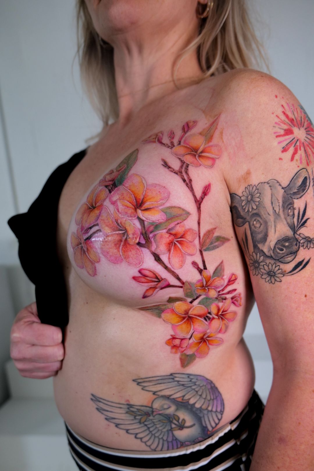 Color Realism tattoo by Sherri Anne Austria: plumeria flowers, branches, cow, dove