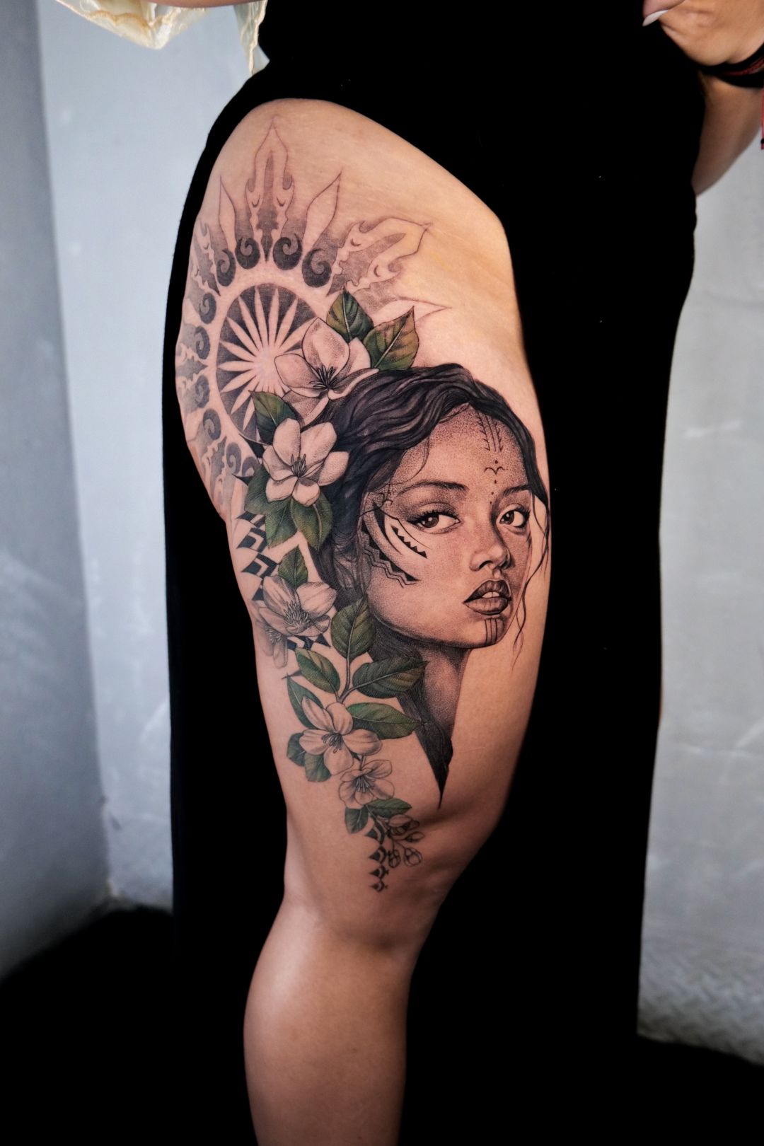 Black & Gray Realism tattoo by Sherri Anne Austria: woman, flowers, leaves, sunburst pattern
