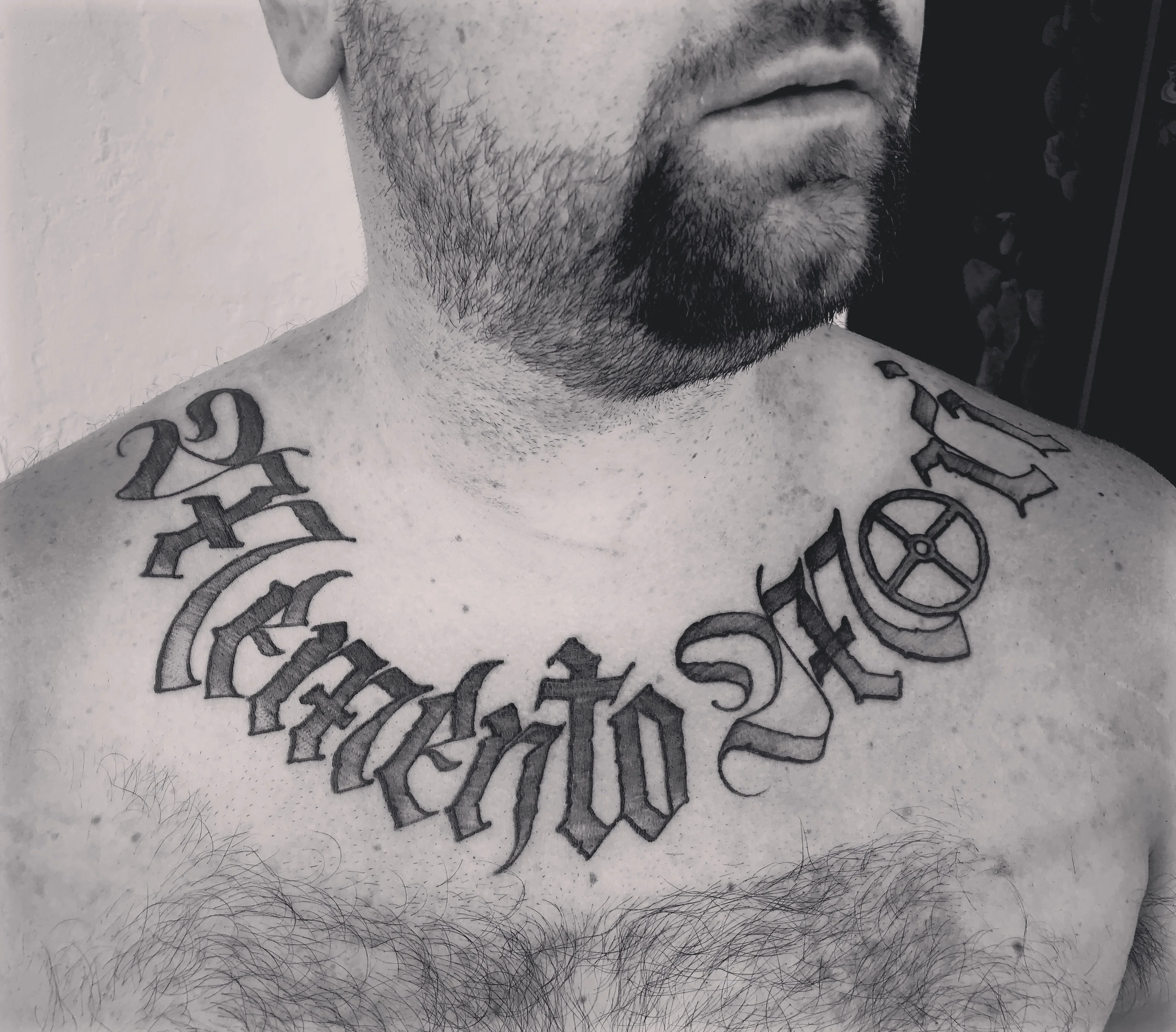 Blackwork tattoo by Justin Wilson: memento mori, cross, wheel symbol, gothic