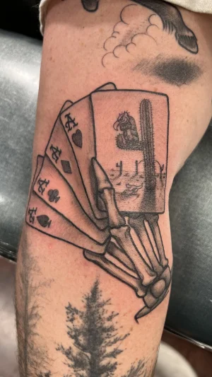Skeletal Hand Holding Playing Cards