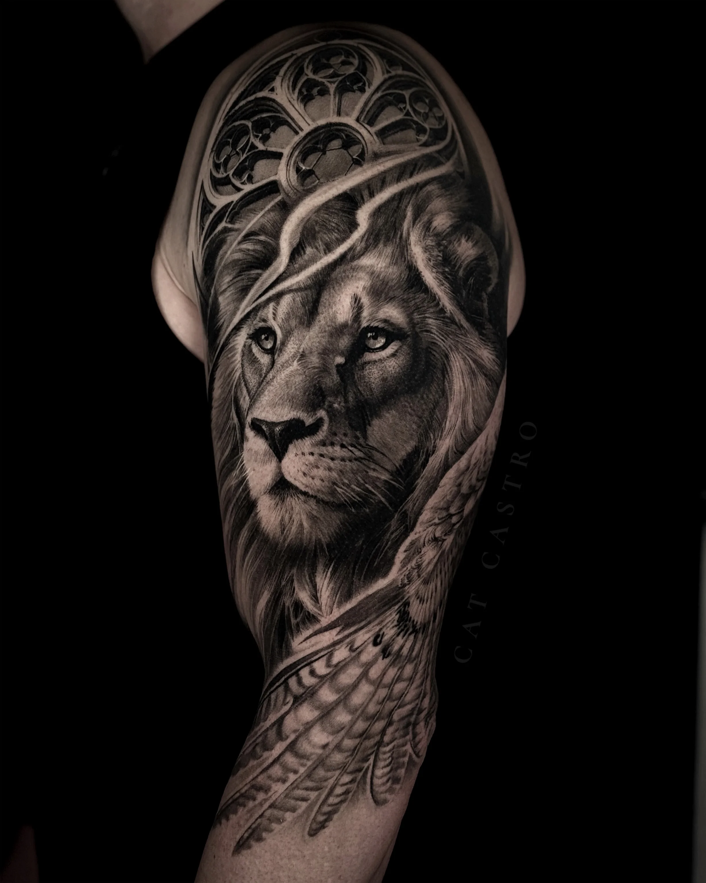 Black & Gray Realism tattoo by Cat Castro: lion, wings, stained glass window, animal