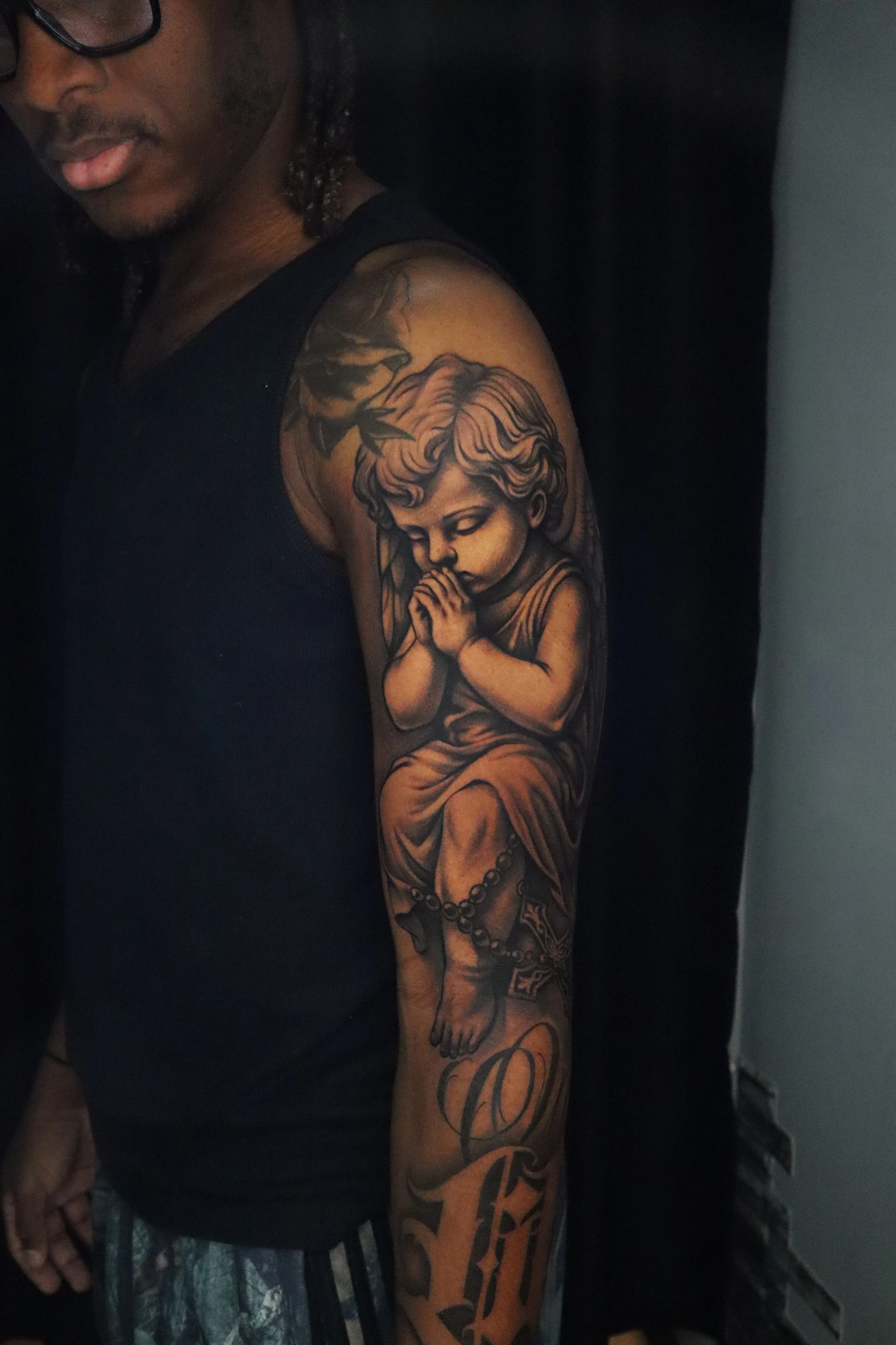Black & Gray Realism tattoo by Kerasu: angel, praying child, rosary, religious