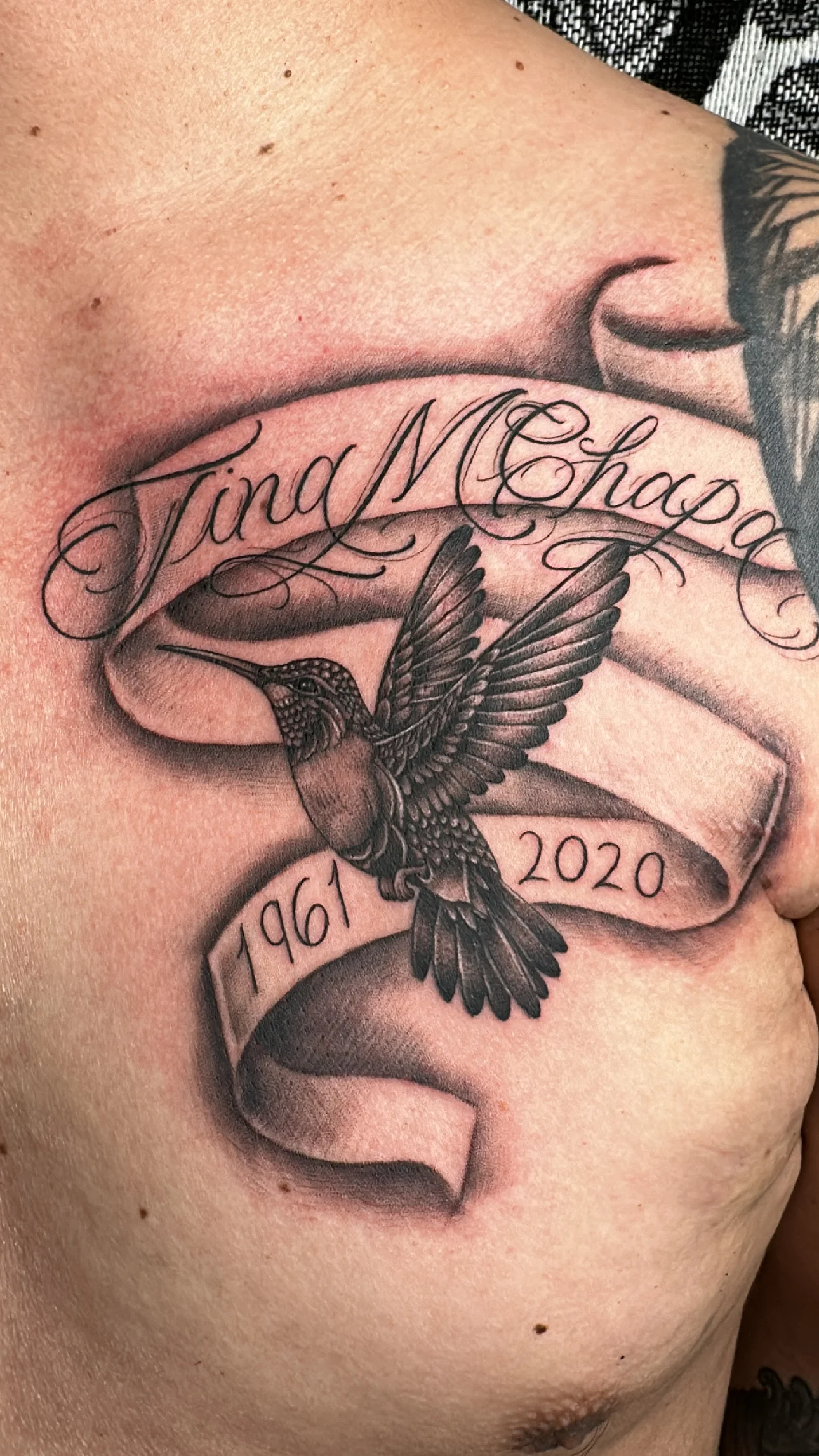 Black & Gray Realism tattoo by Bumpy Munoz: hummingbird, banner, script, dates