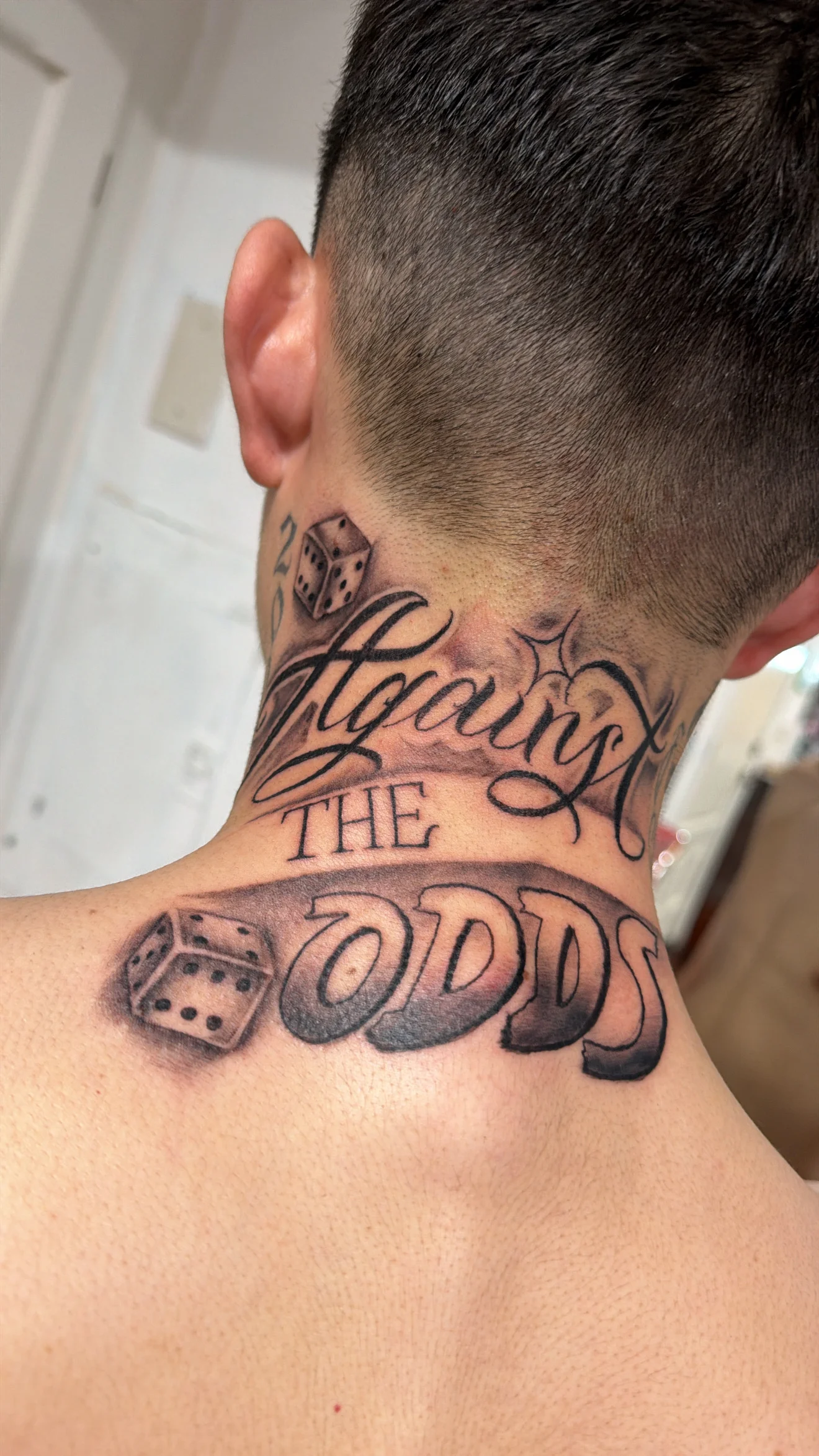 Black & Gray Realism tattoo by Bumpy Munoz: dice, script lettering, luck, gaming