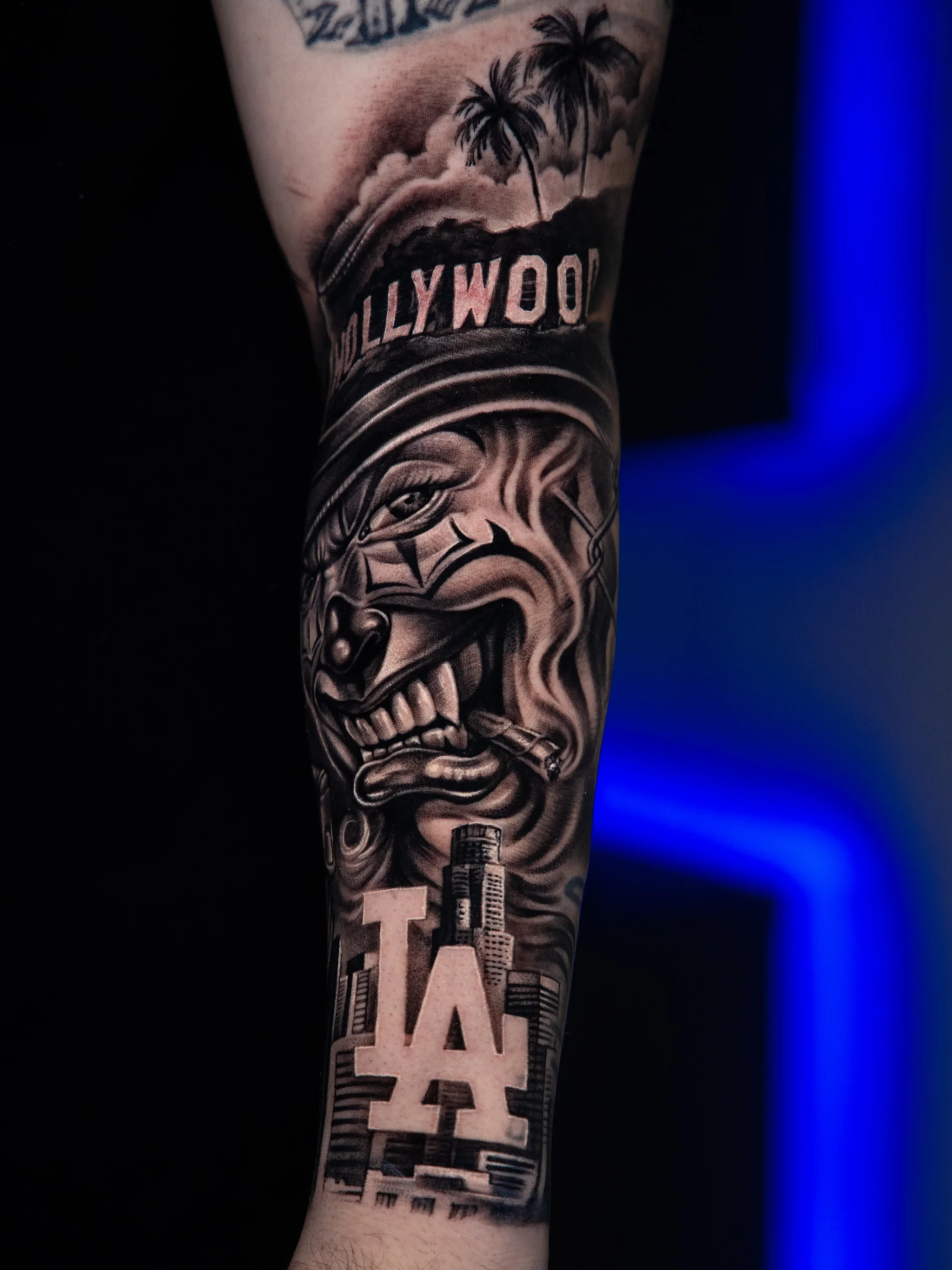 Los Angeles Clown Forearm: clown face, cigarette, hollywood sign, palm trees, los angeles skyline, la letters