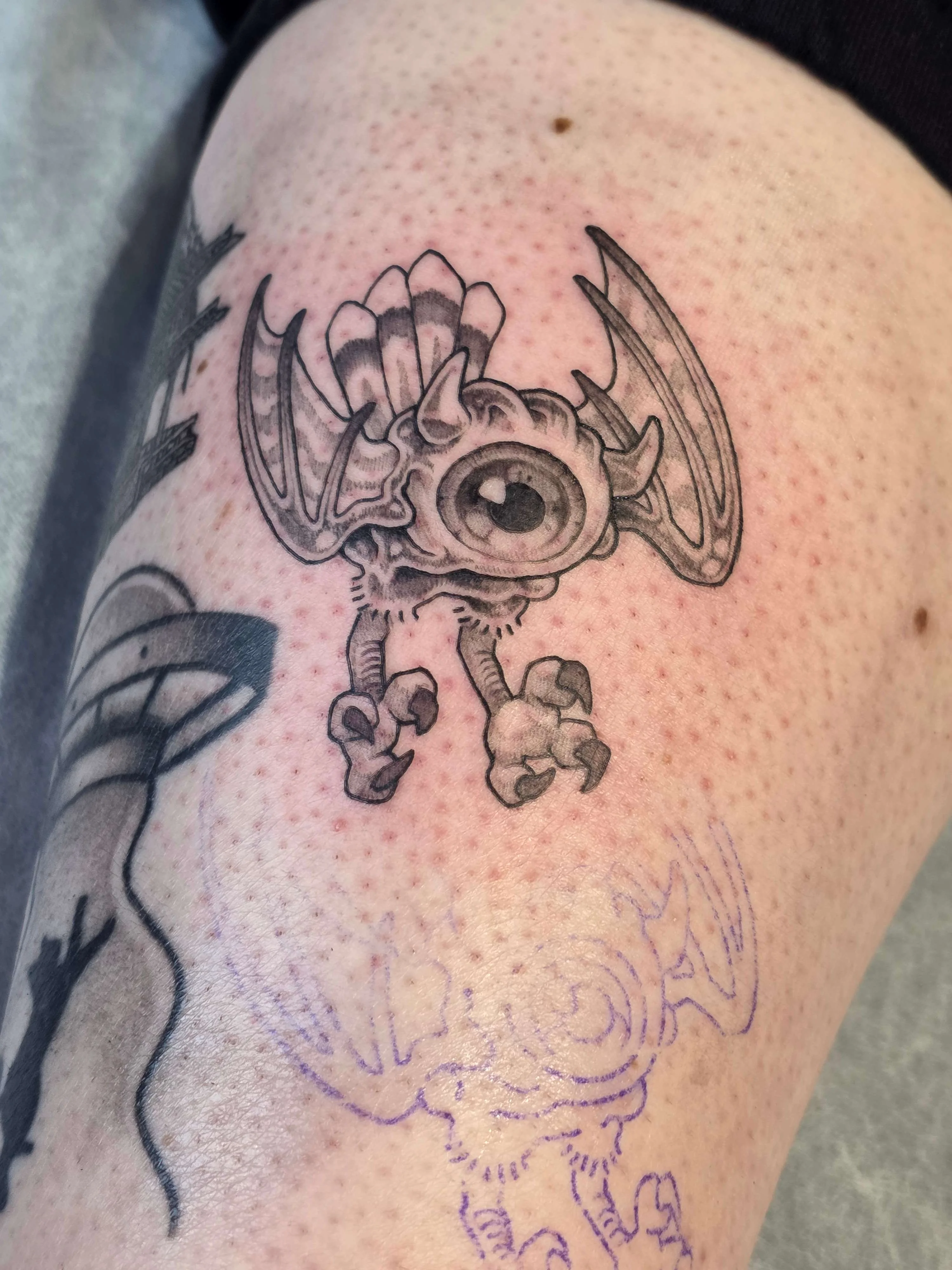 Illustrative tattoo by UrchinBite: cyclops skull, bat wings, claws, horns